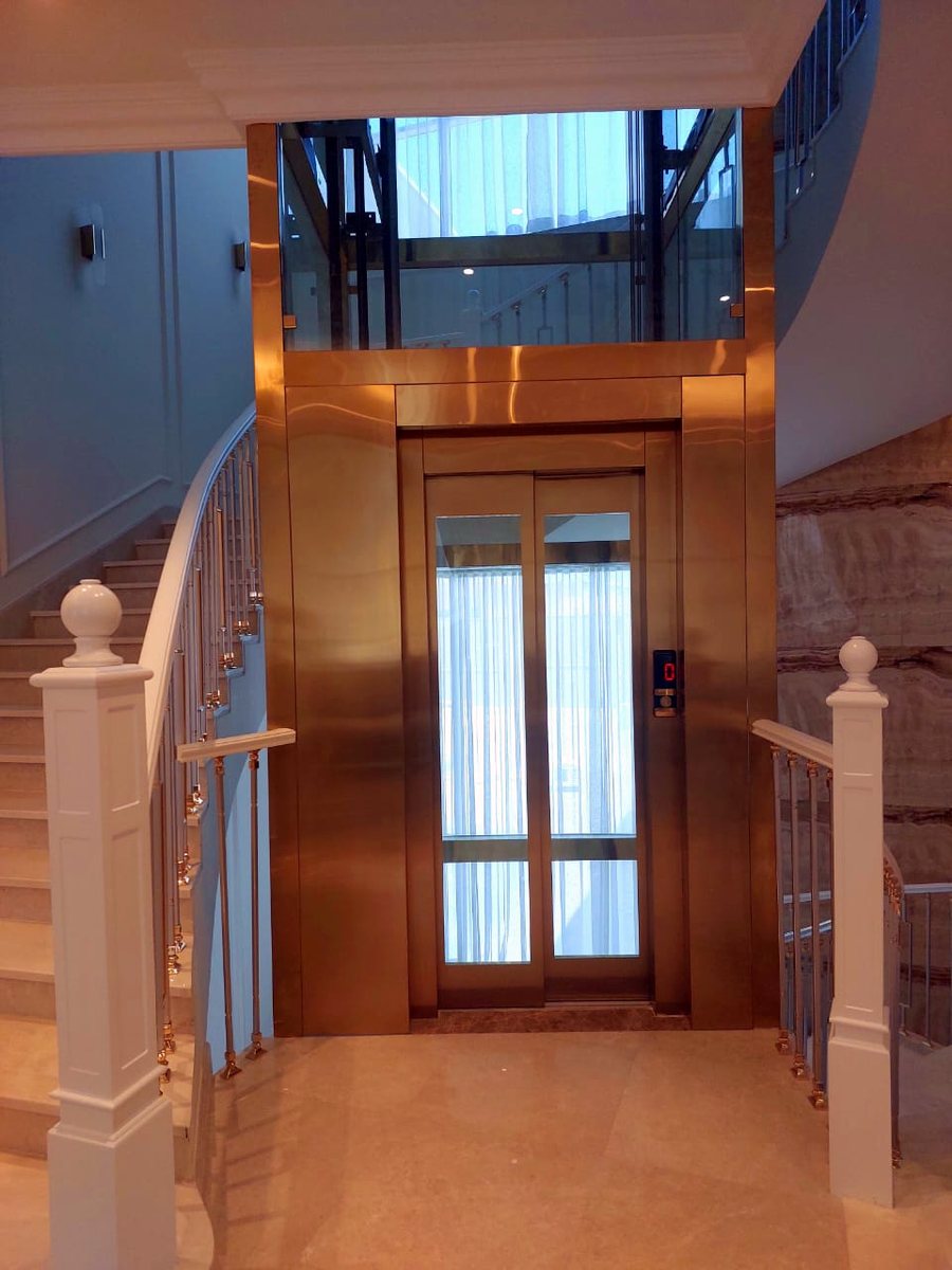 Villa lift with gold doors