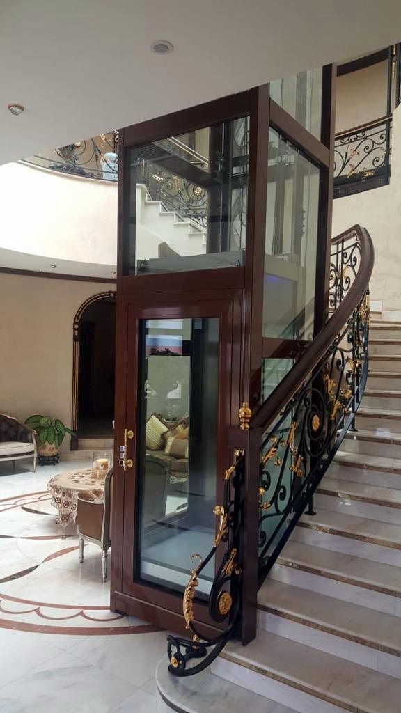 Villa panoramic lift with timber and glass shaft